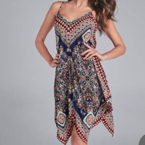 The handkerchief hem of this midi dress adds a unique twist